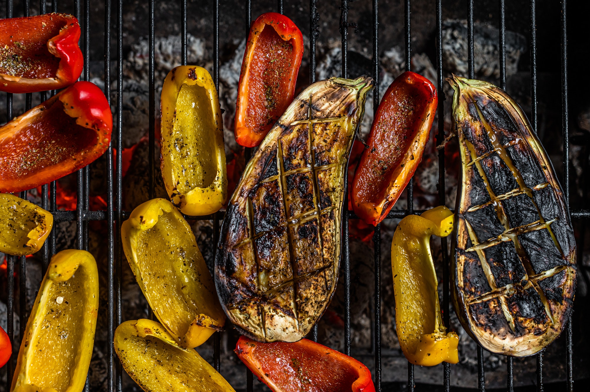 Grilled vegetables on barbecue, outdoor BBQ grill with fire. Top view